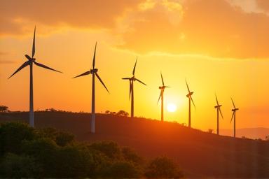 Wind turbines on a hill at sunset